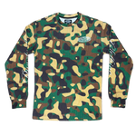 A long-sleeve crewneck shirt featuring a green, brown, and tan camouflage pattern, with a small oval logo on the left chest and white graphic prints on the sleeves.