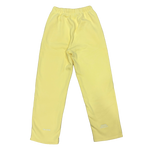 A pair of light yellow athletic pants with an elastic waistband and small white embroidered logos near the lower hems, shown flat against a white background.